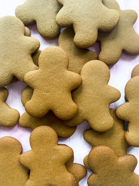 gingerbread man cookies on a white plate with no frosting