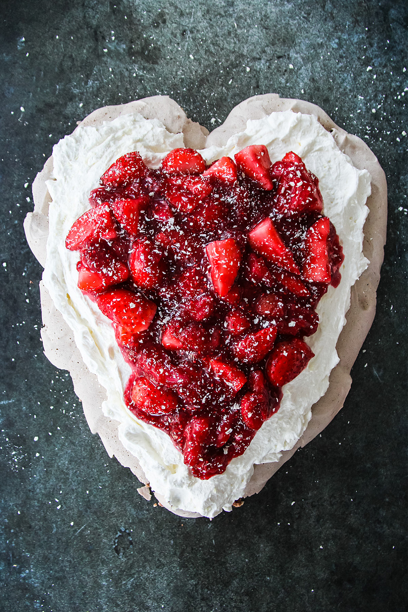 Chocolate pavlova with strawberries shaped as a heart for Valentine's Day.