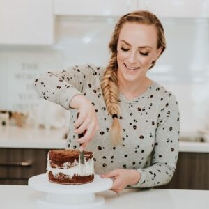 woman decorating a cake