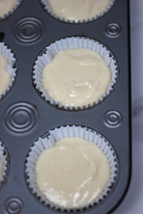 almond cupcake batter in liner ready to be baked
