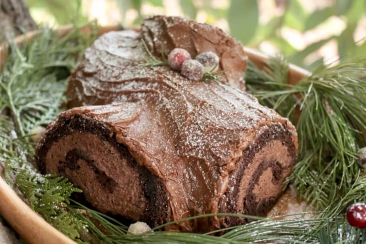 gluten free yule cake on a plate with greenery
