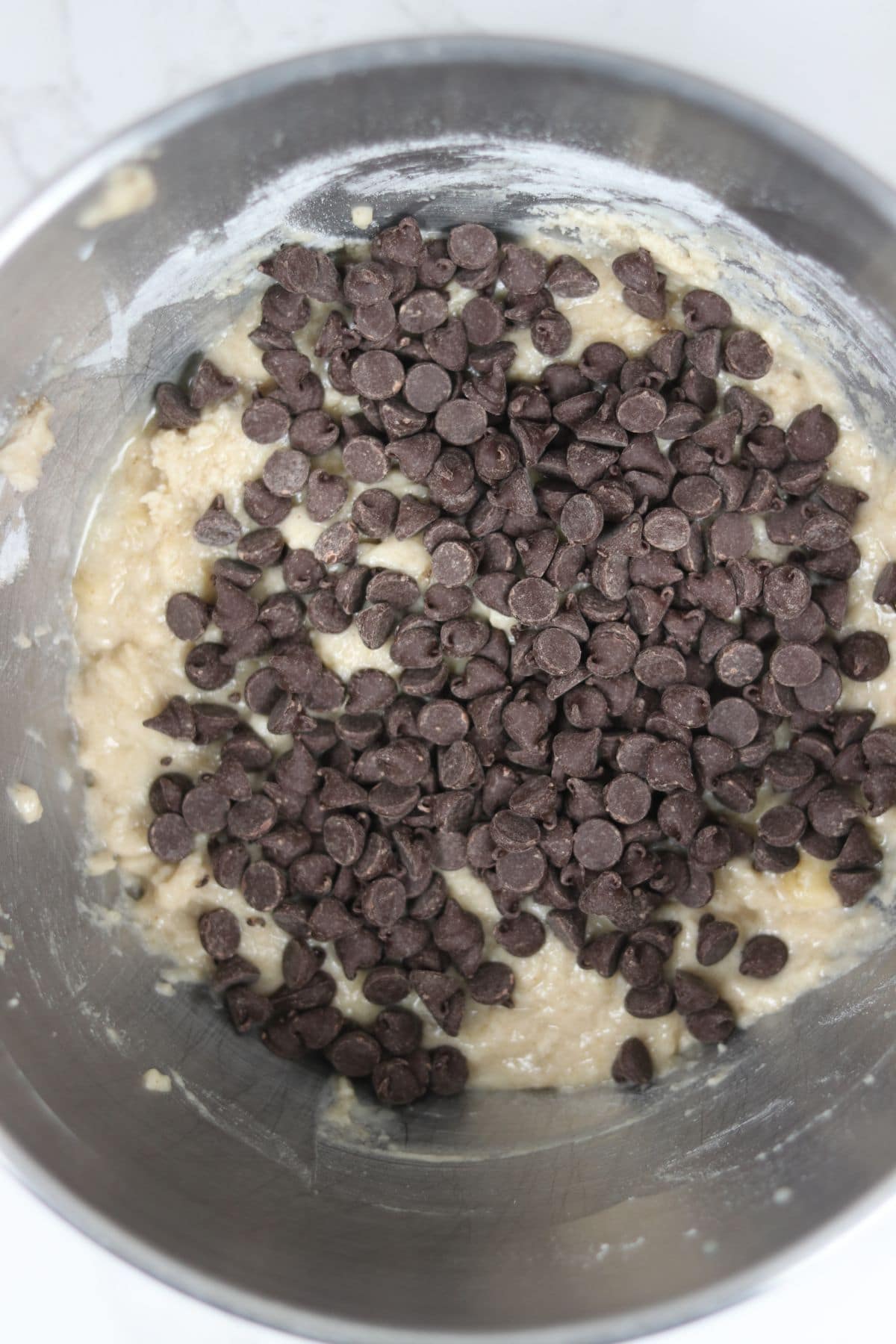 chocolate chips about to be folded into banana bread sans gluten batter