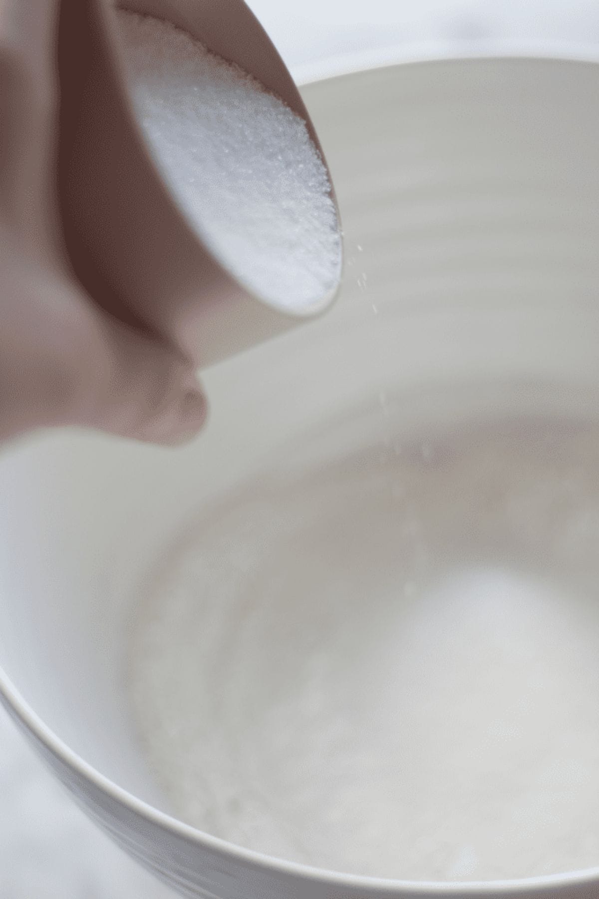 sugar being poured into the bowl