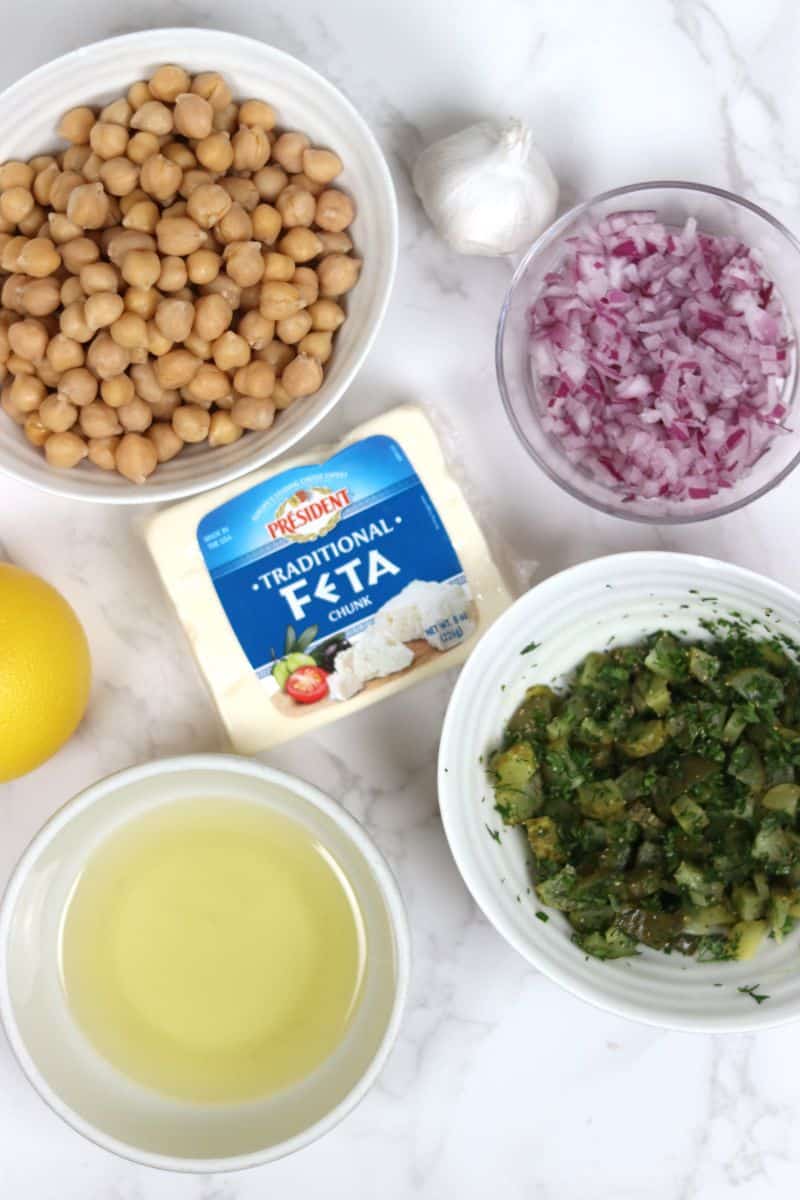 ingredients needed to make dill pickle chickpea salad all on a plate