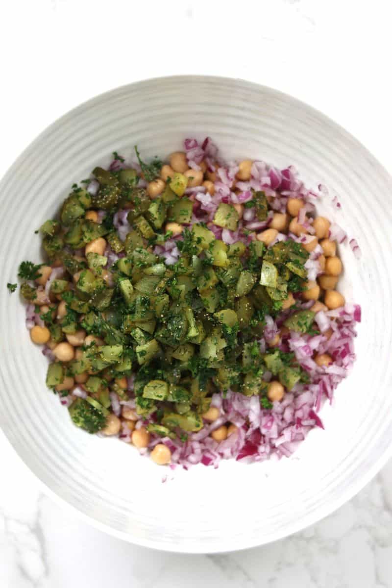 chickpeas, red onion, and pickles in a bowl