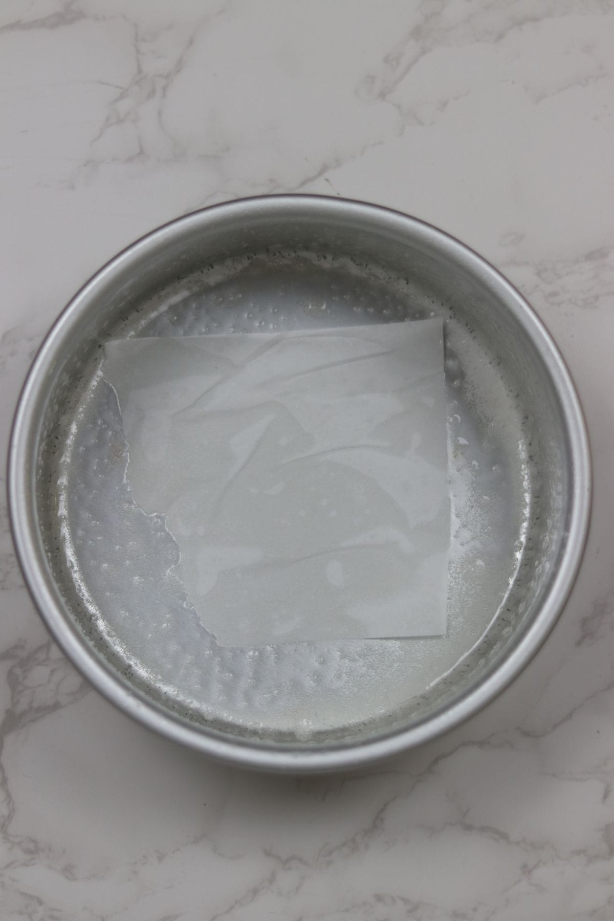 a pan sprayed with baking spray and parchment in bottom