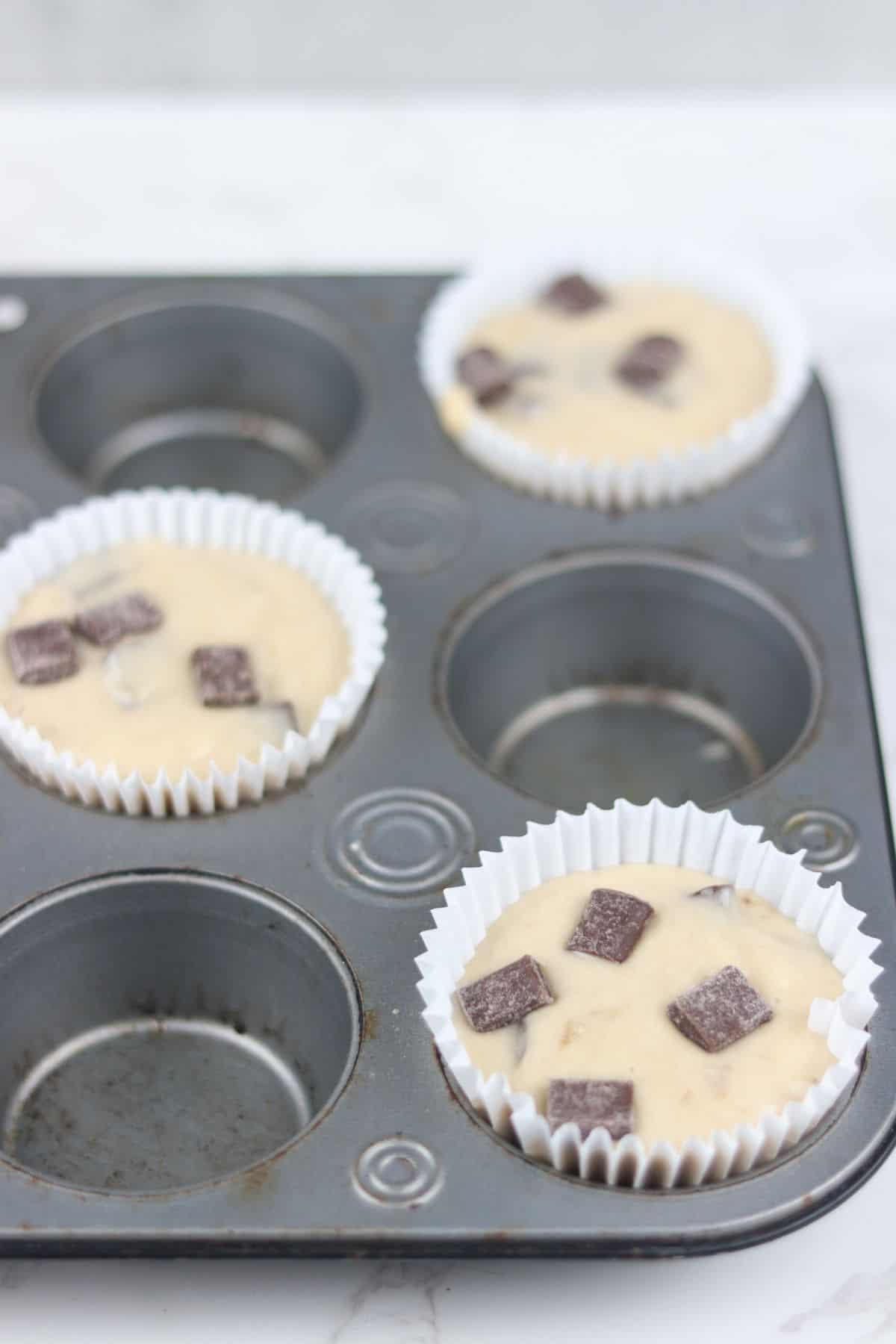 bakery style banana muffin batter in muffin pan