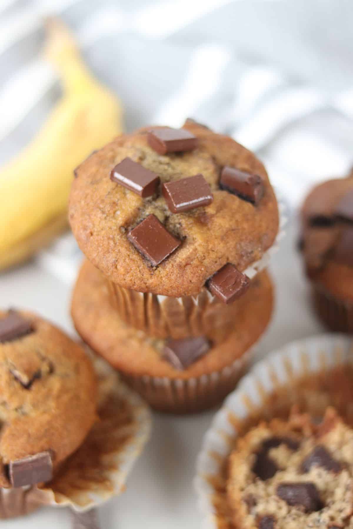 bakery style banana muffins stacked on top of one another