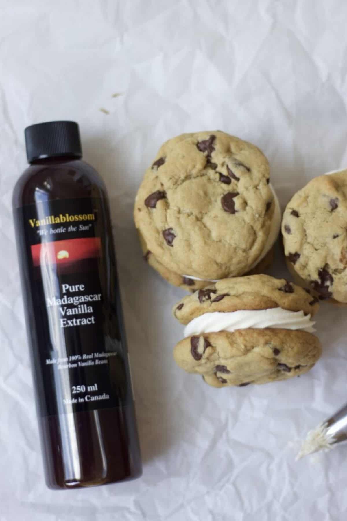 chocolate chip cookies sandwiches next to a bottle of vanilla