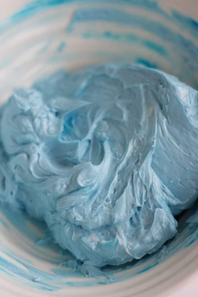 blue swiss merignue buttercream in a bowl