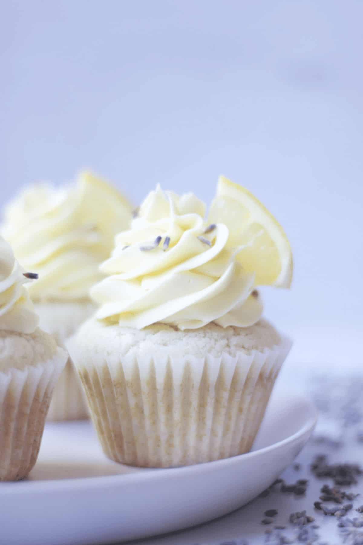 close up of lavender lemon cupcakes on a plate