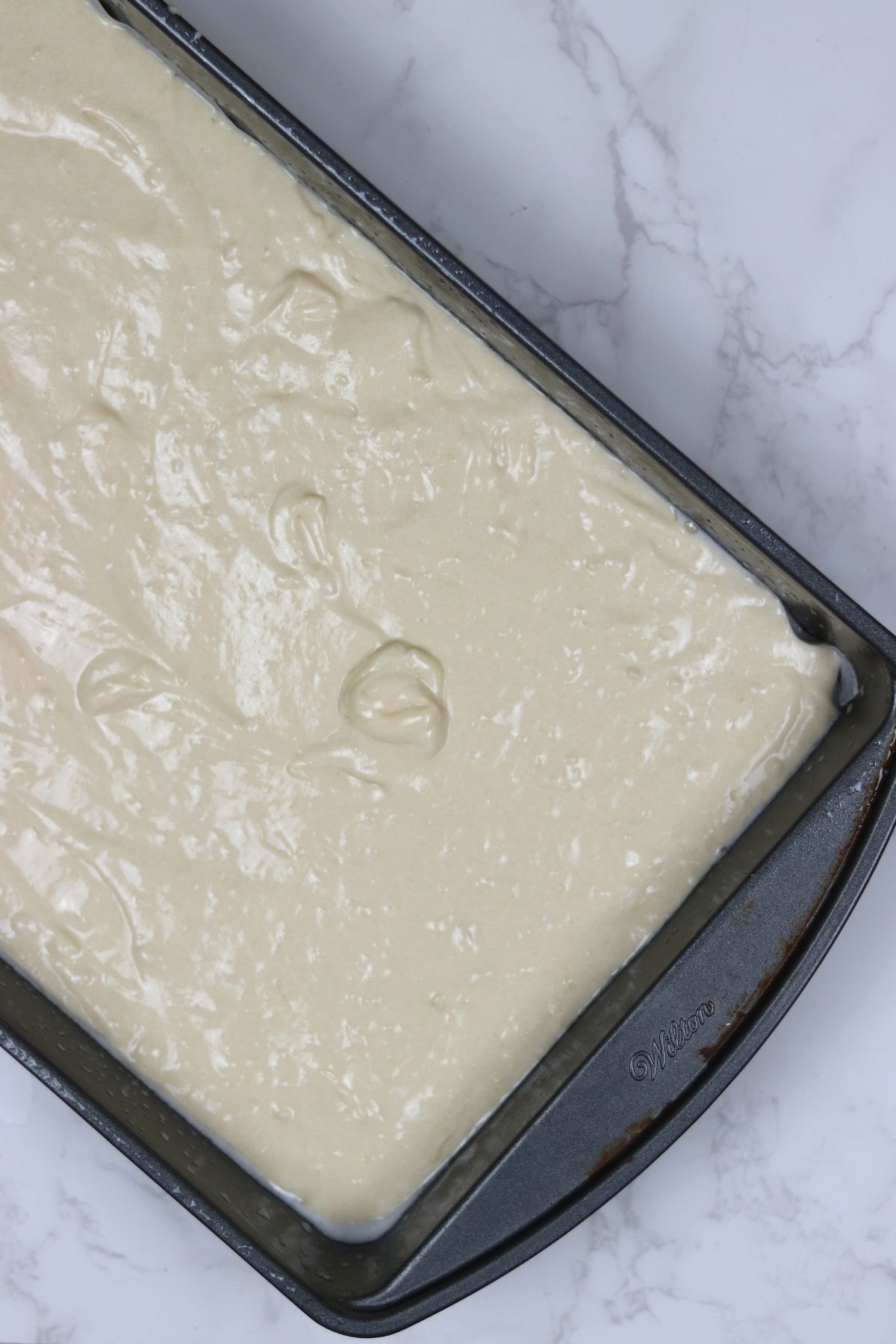 vanilla tray bake batter in a rectangular pan